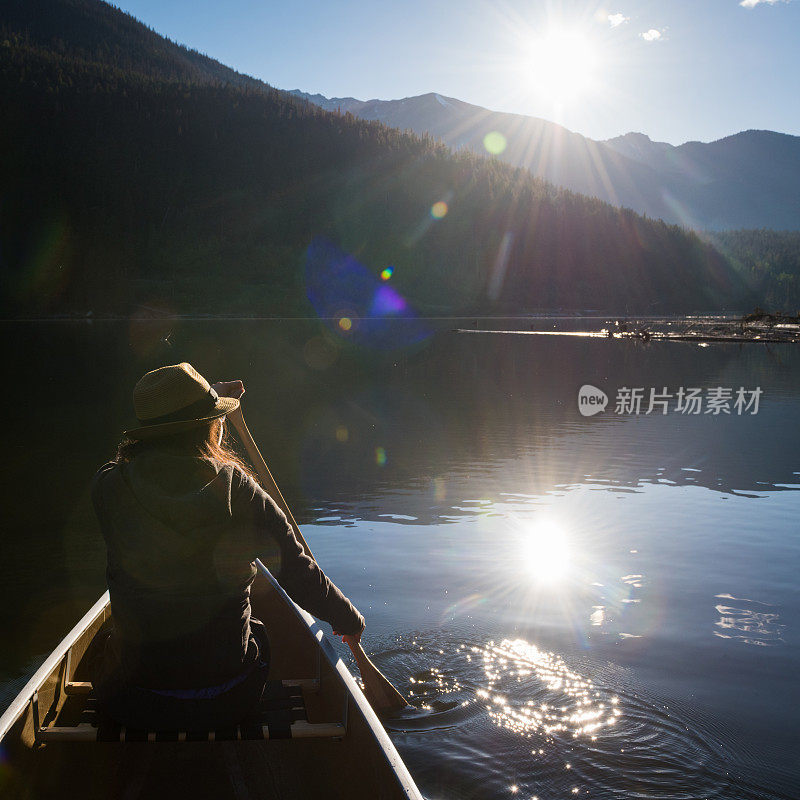 女人在日出时划独木舟