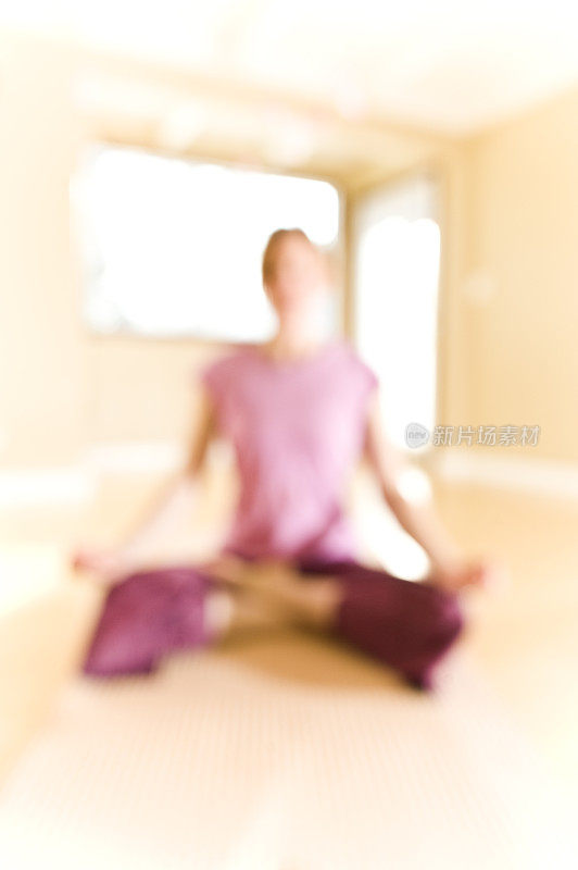 软焦点背景的女人冥想做瑜伽在工作室