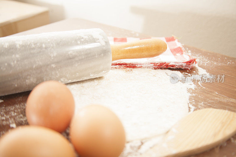 烘焙的概念。厨房柜台上的擀面杖，勺子，面粉，鸡蛋。