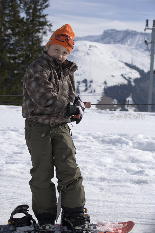 小男孩在滑雪板上
