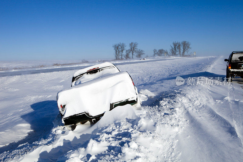 一辆卡车被困在了高速公路上的大雪中