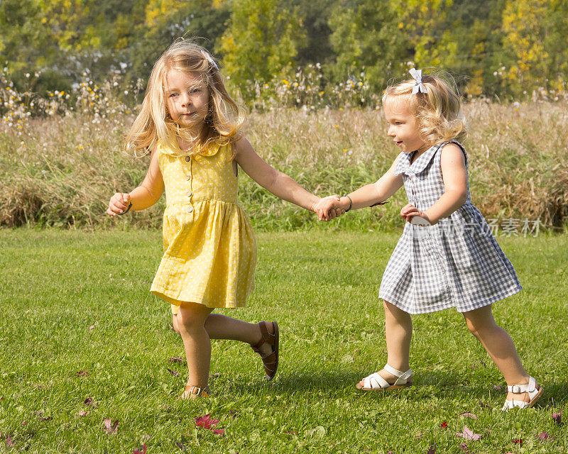 两个可爱的女孩一起奔跑在农村秋天的设置