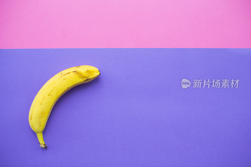 粉红紫罗兰背景上的香蕉