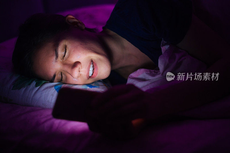 躺在床上玩手机的女人
