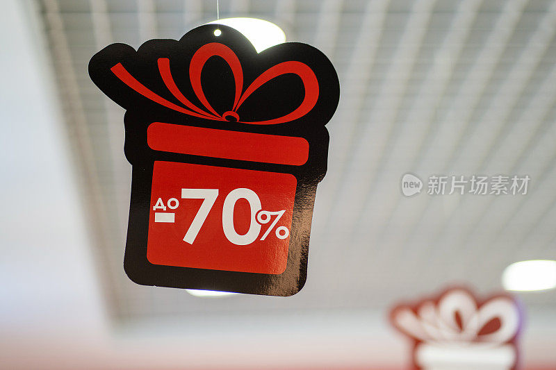 商店天花板上的贴纸，以礼物的形式出现，还有-70%的折扣图标。“黑色星期五”。网络星期一。
