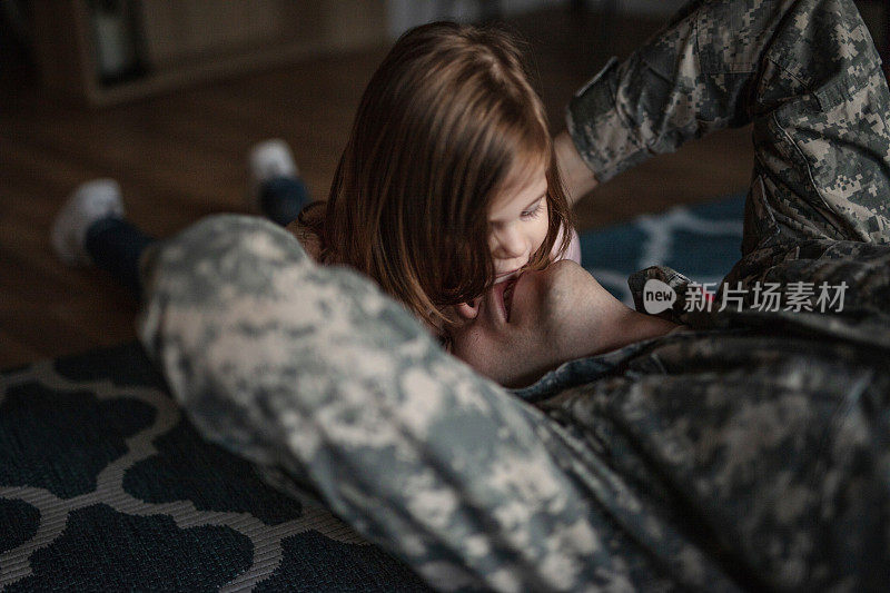 一个军人和他的女儿接吻玩耍