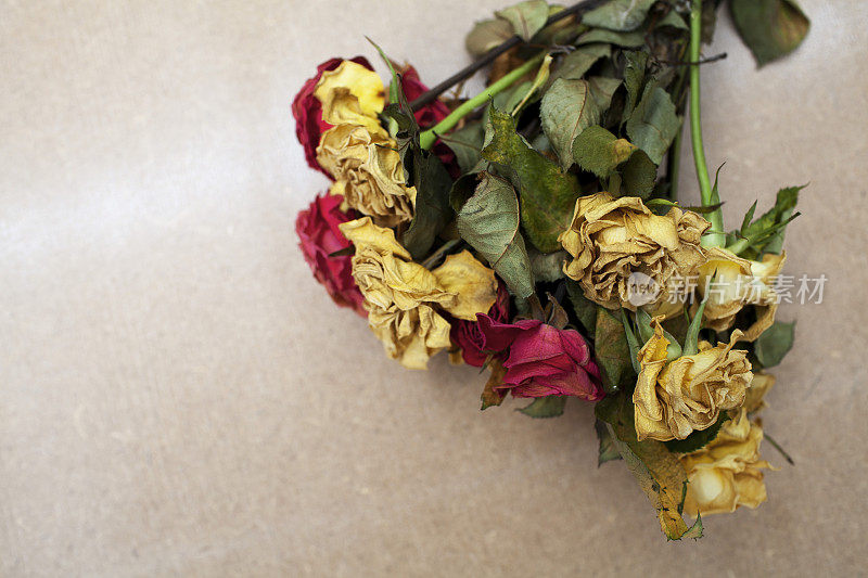 花束死玫瑰在硬木纹理与复制空间