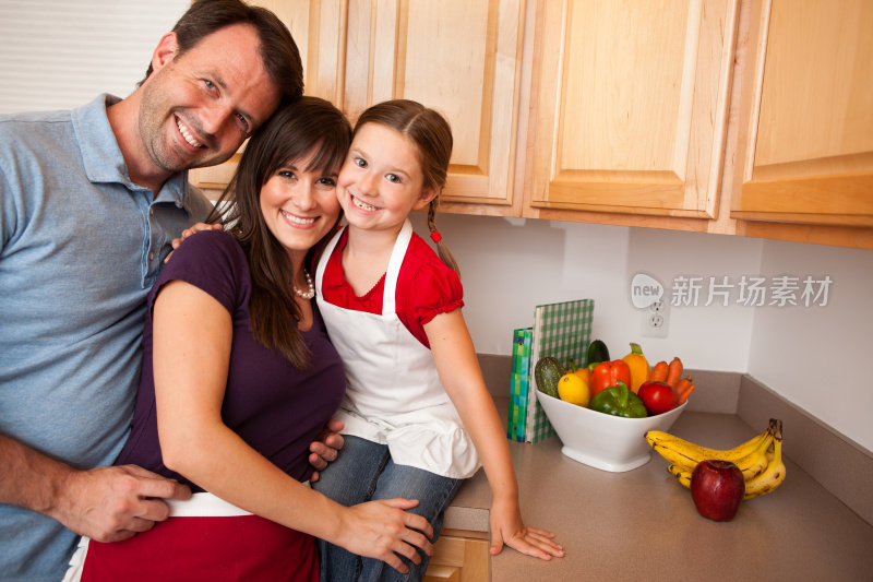 幸福家庭在厨房微笑，水果和蔬菜