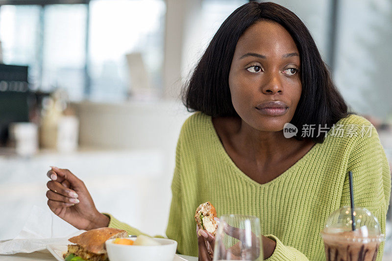 年轻的黑人妇女在吃午饭