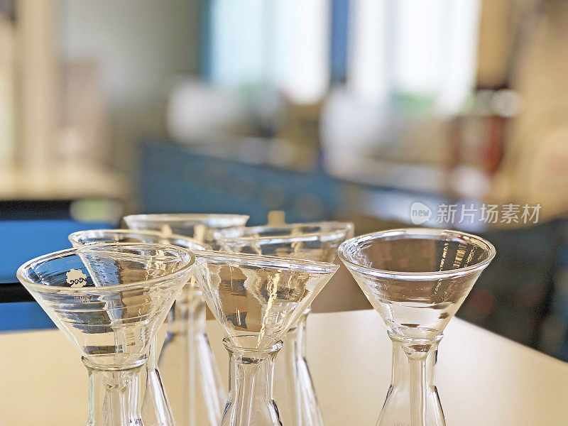 带滤液漏斗透明玻璃器皿的锥型烧瓶，用于科学实验台上过滤化学固体或液体样品。化学室或医疗室要清洁并保护污染。