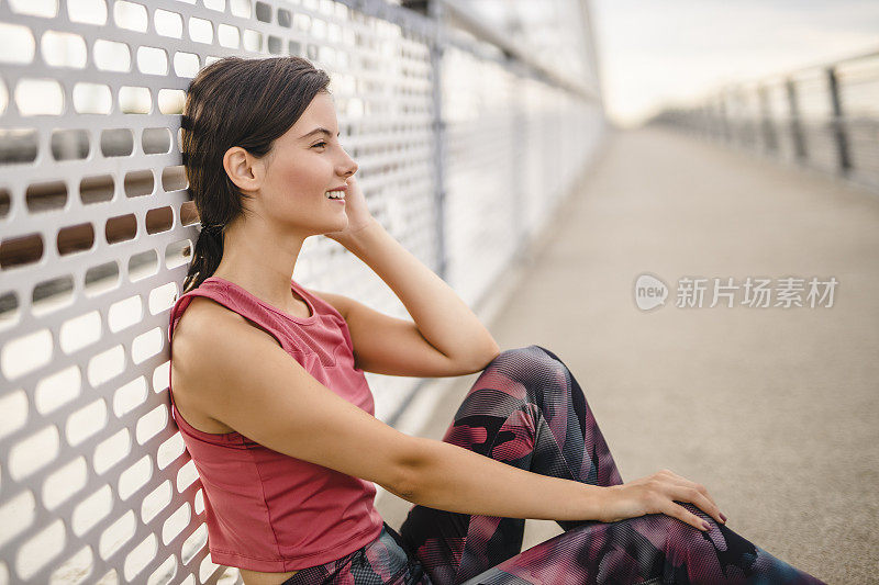 运动的年轻女子，在户外慢跑后休息