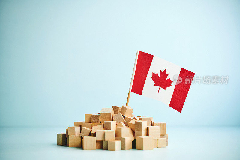 蓝色背景上的一堆木块和加拿大国旗
