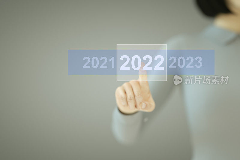 2022年新年，商务女性按下触摸屏上的按钮