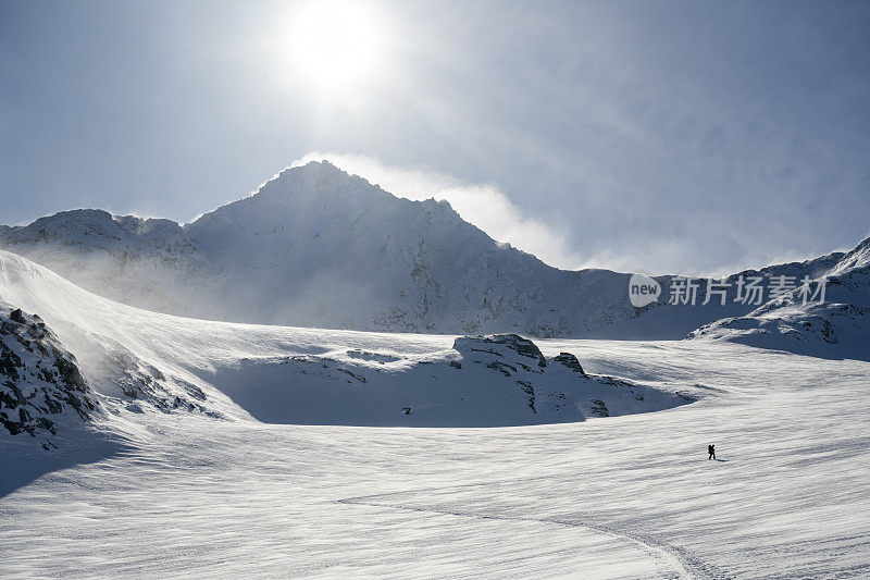 滑雪登山运动员登上白雪皑皑的山峰