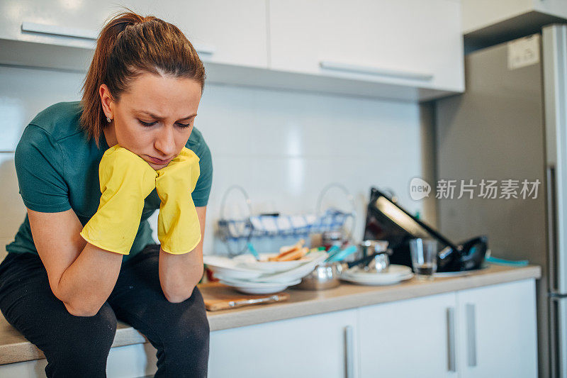 闷闷不乐的家庭主妇坐在厨房里