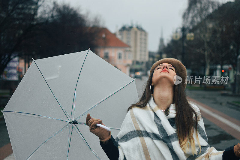 美丽的年轻女子享受着雨天