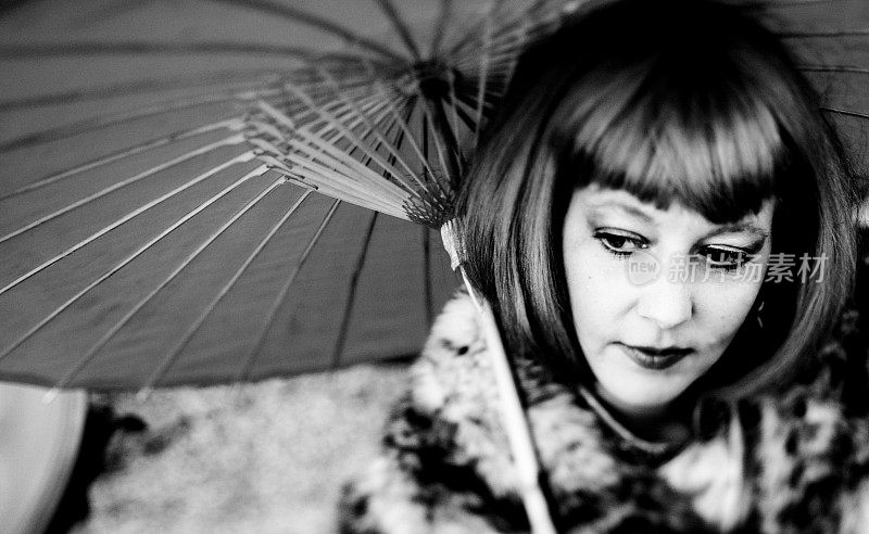 一个打着阳伞的女人的黑白图像