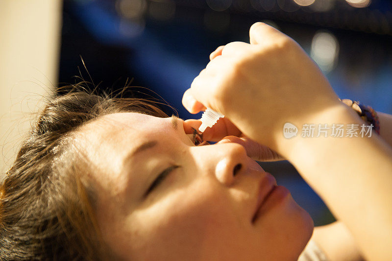 一个日本女人在用眼药水