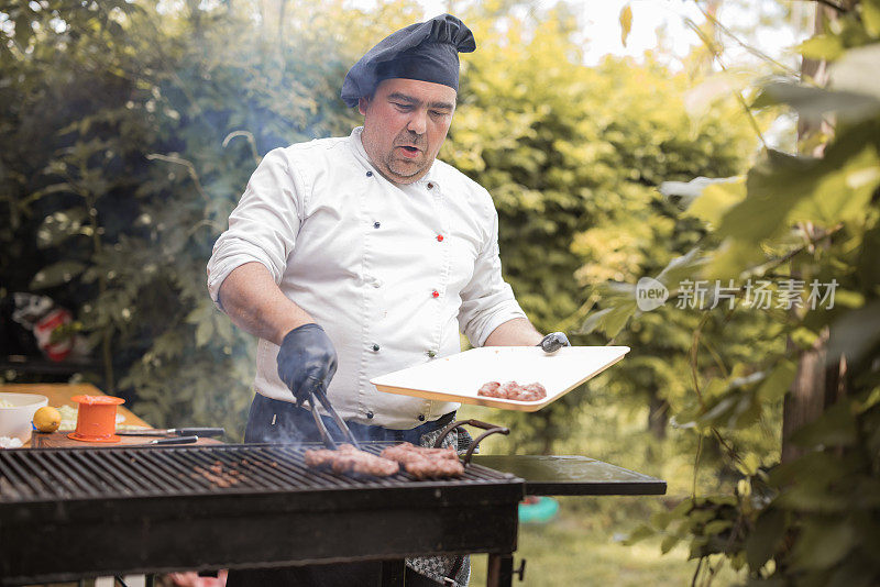 厨师把肉放在烤肉架上