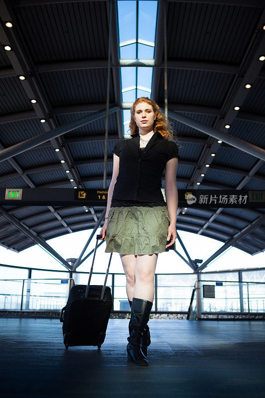 机场一红发女子带着卷袋