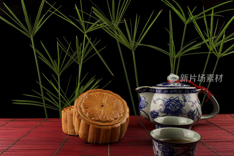 红竹席上放着月饼和茶