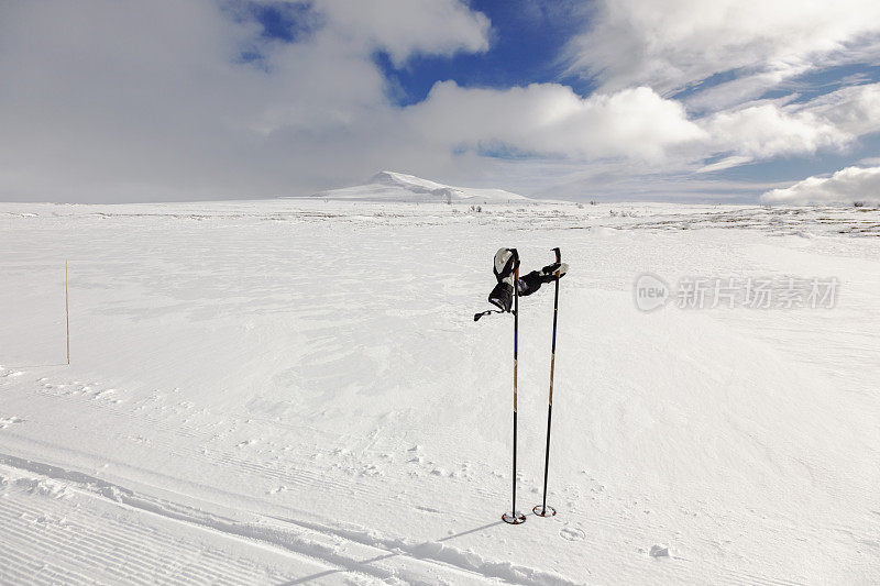 冬季的山地景观有滑雪道和滑雪杆。