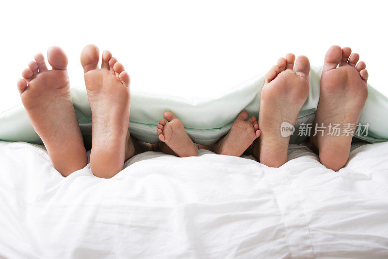 家庭脚在床上的特写