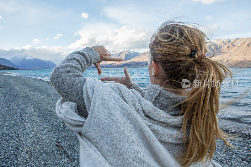 湖边的年轻女子在湖面上勾勒出自然的画面