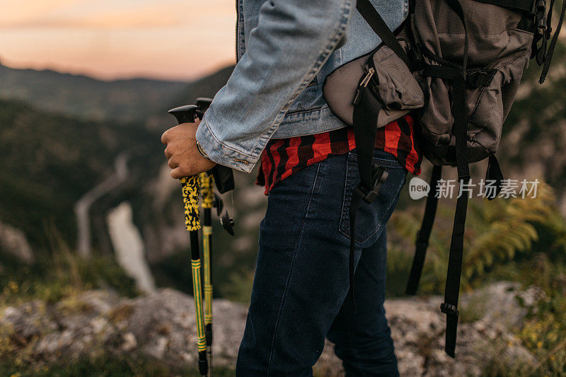 在山上拿着登山杖的徒步者