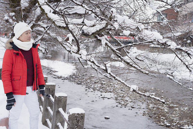 游客们在下雪的冬天享受他们的日本之旅。