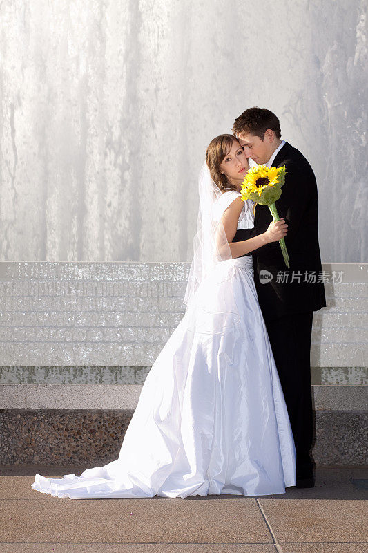 新郎和新娘站在喷泉前