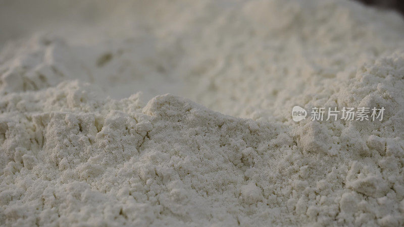 易碎的白面粉的特写。资料片。白色的纯面粉在烘烤前要经过过滤。白色的，稠密但易碎的粉末或面粉