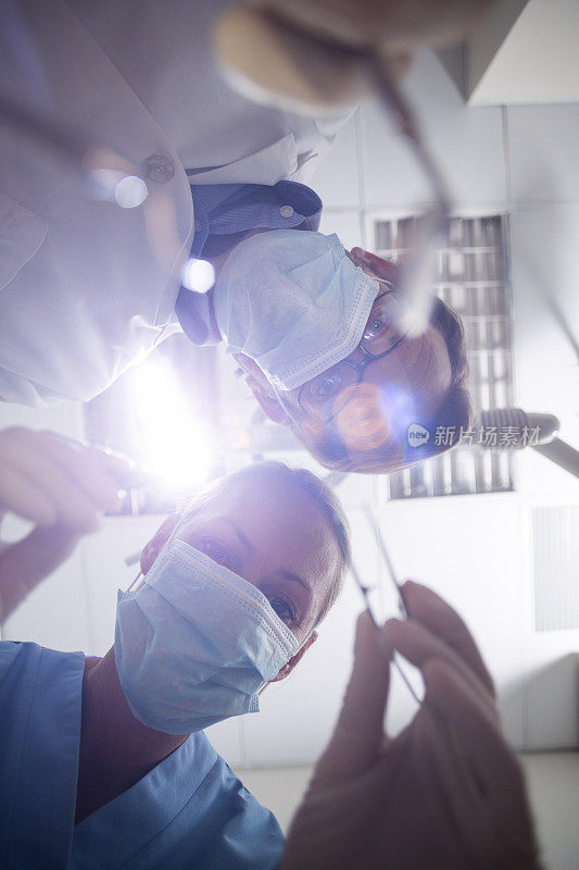 牙医戴着外科口罩拿着牙科工具
