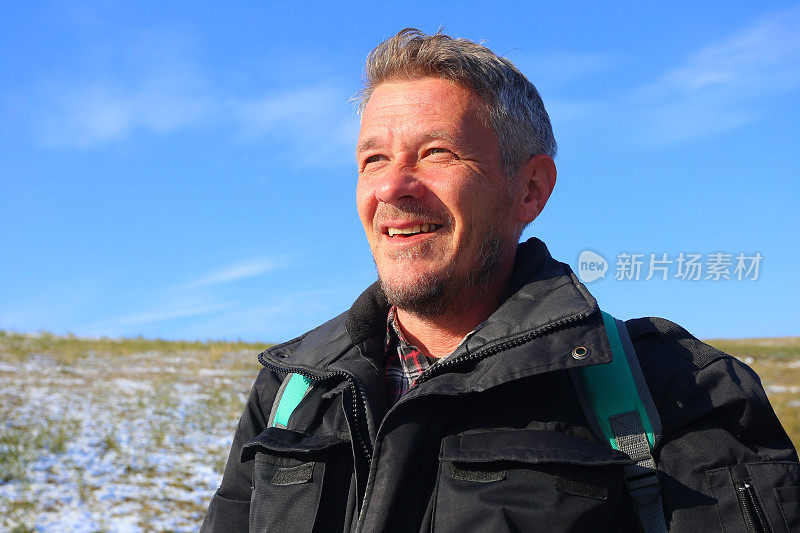 成年男子徒步旅行在下雪的冬天的自然