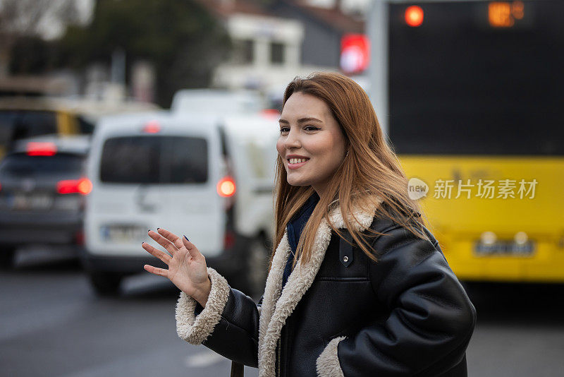 年轻女子正在街上叫出租车。