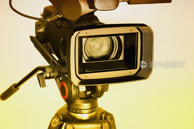 视频摄像机在白色背景下用暖光广角镜头拍摄，专业视频拍摄，用专业摄像机拍摄视频