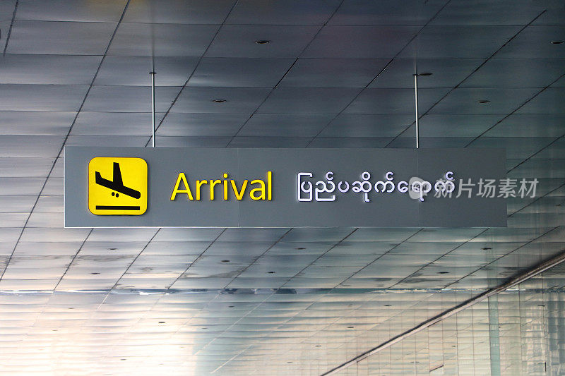 英语和缅甸语的抵达标志，黄色和黑色的飞机着陆标志。