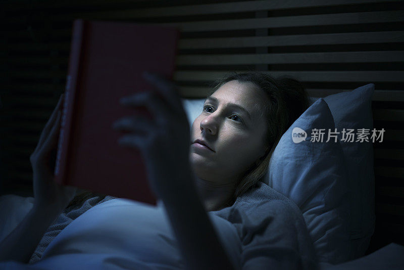 女人晚上在床上看书