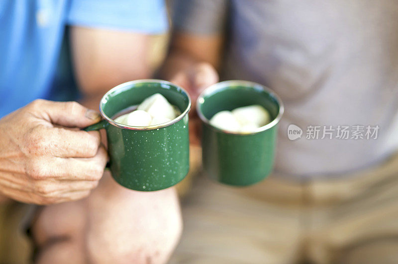 手里拿着一杯带棉花糖的热可可