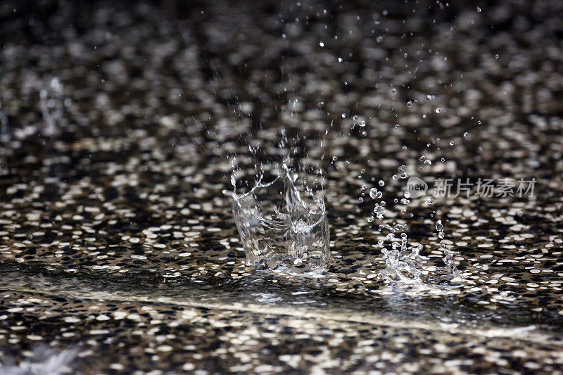 新加坡:雨滴在水坑里溅起水花