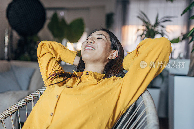 一位年轻的日本妇女正在家里的椅子上休息