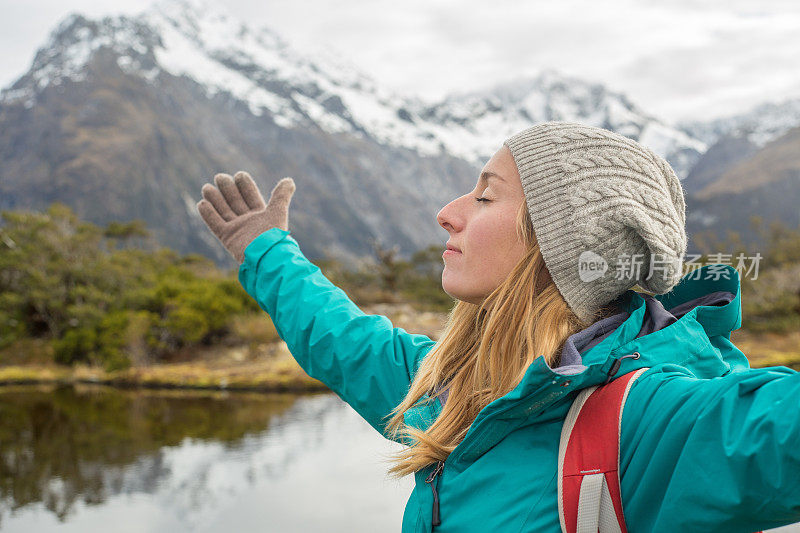 徒步旅行者在山景中伸开双臂的肖像