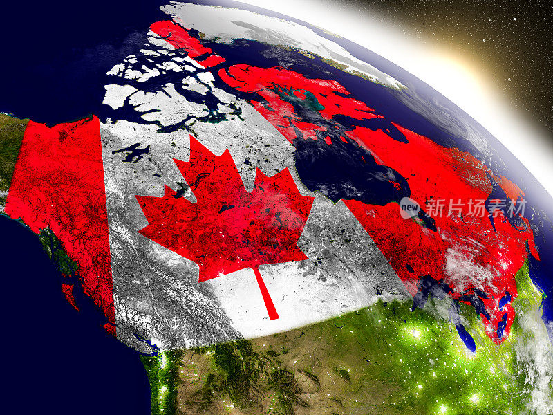冉冉升起的朝阳中飘扬着国旗的加拿大