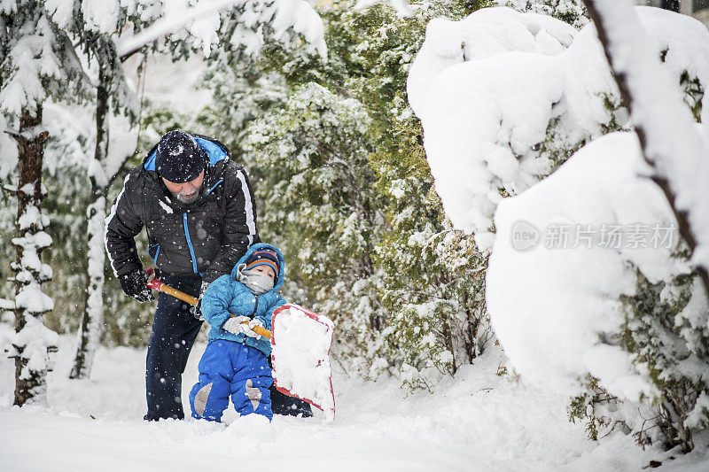 在冬天的一天，爷爷和孙子在清理积雪
