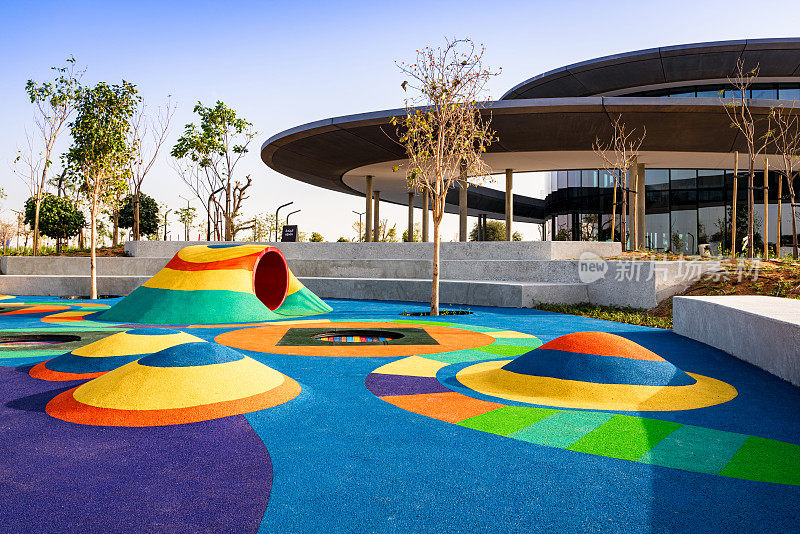 沙迦公园的儿童游乐场，有许多彩色的橡胶堆和隧道，到处都是玩耍设备，秋千，滑梯，蹦床