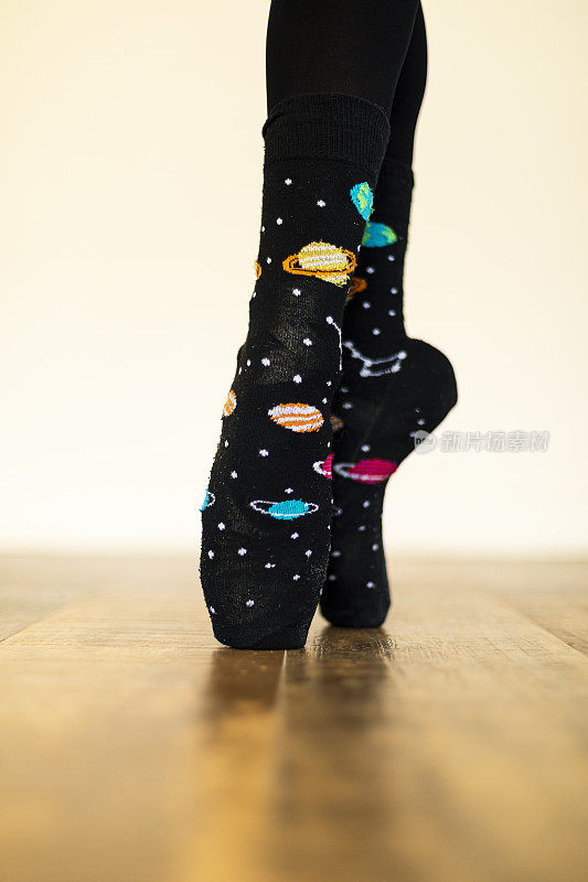 女孩穿着芭蕾舞鞋覆盖黑色袜子与行星图像