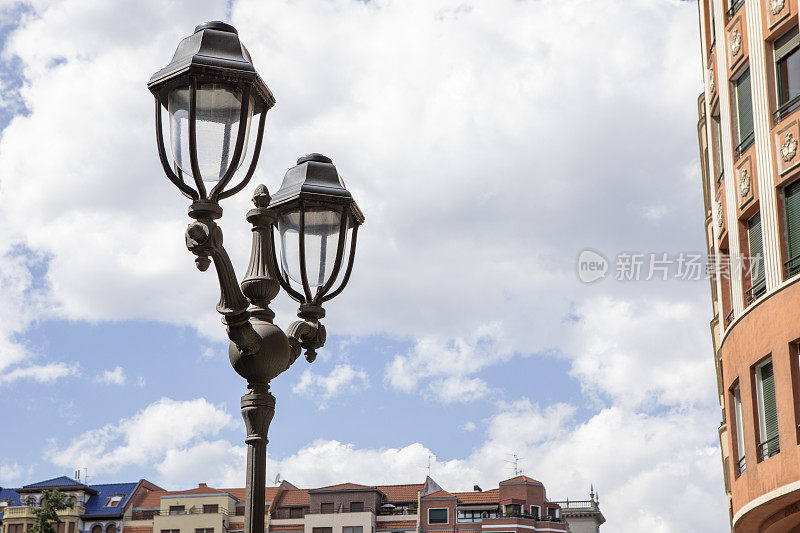传统的西班牙路灯和城市公寓建筑