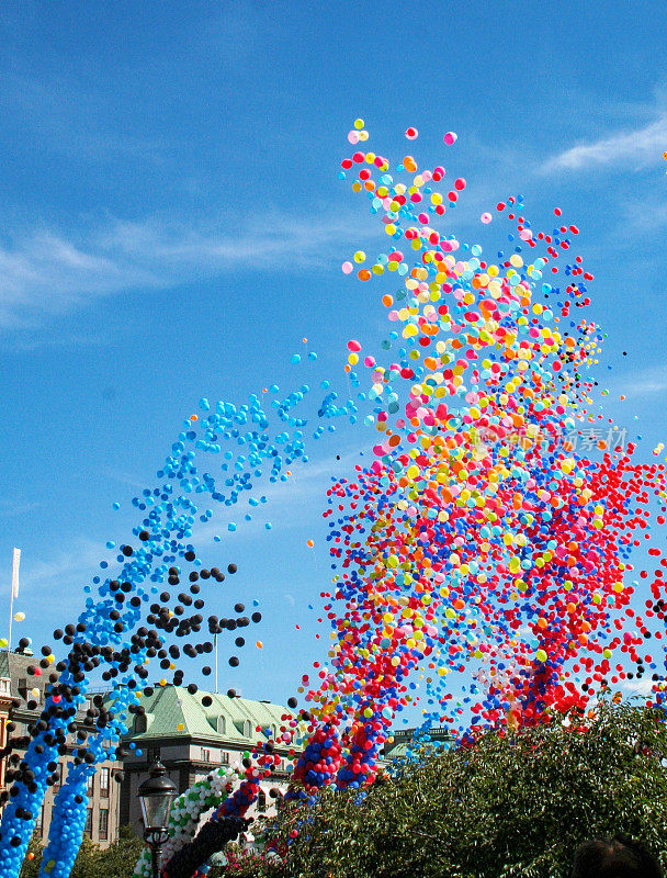 五颜六色的气球映衬着瑞典斯德哥尔摩市的蓝天