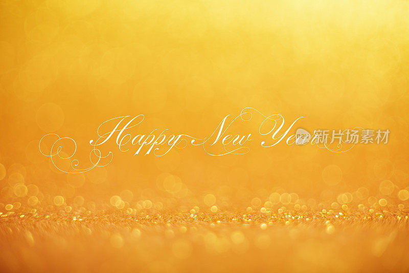 新年快乐的祝福在金色的散景球背景节日和新年的概念背景与闪烁明亮的散景圈