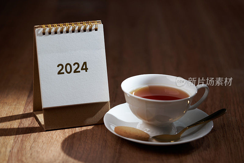 2024台历和木桌上的壁杯热茶